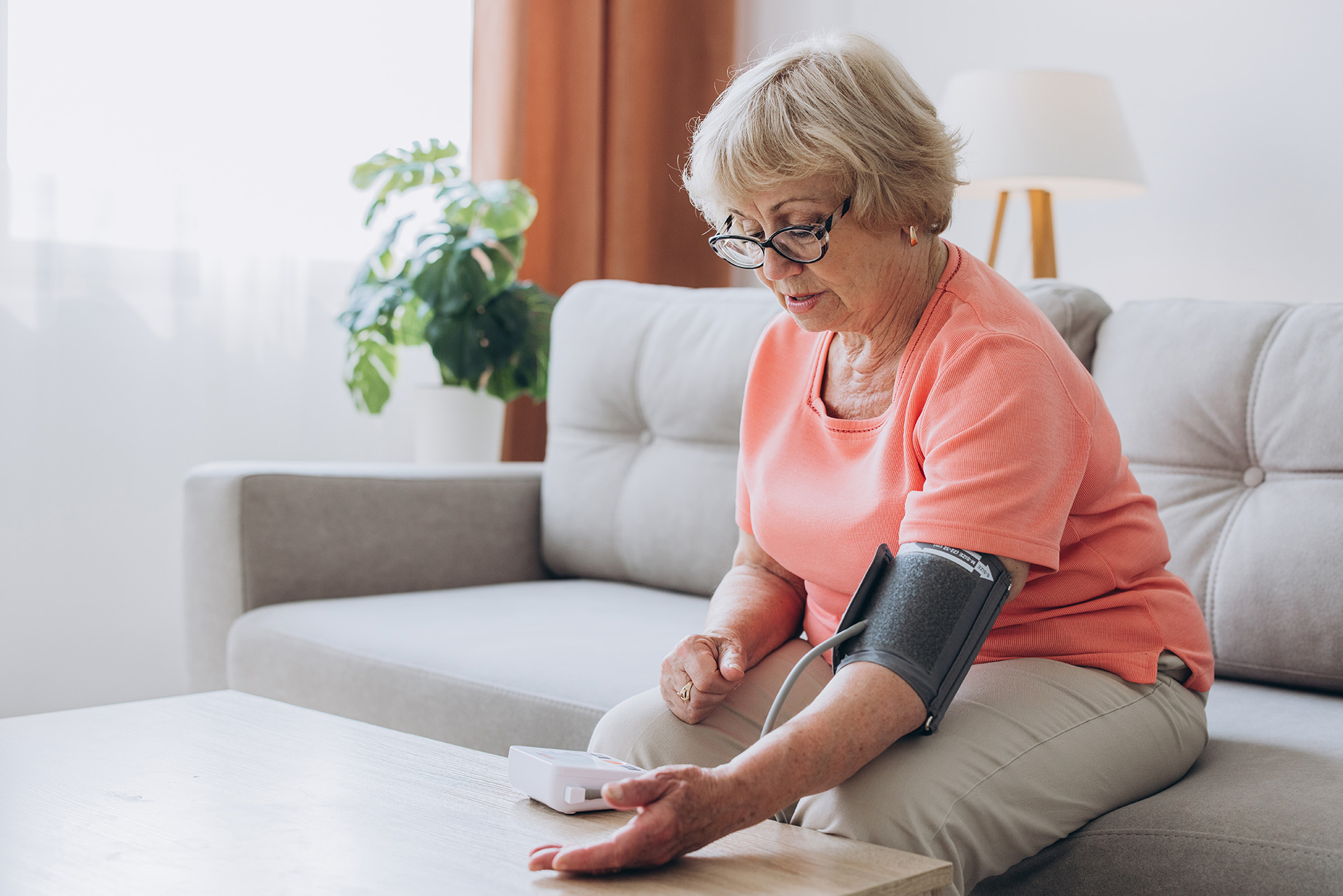 senior citizen women checking her blood pressure